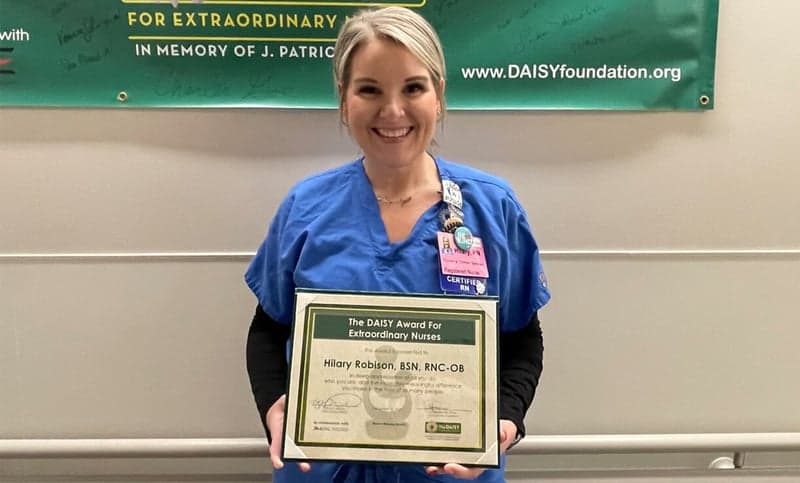 Hilary Robison poses with her DAISY award